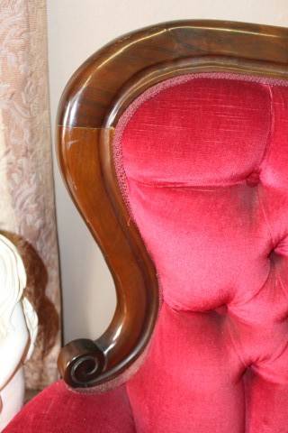 A gorgeous antique Victorian 3 seater settee couch w carved detailing and period style upholstery.