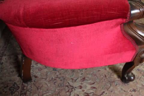 A gorgeous antique Victorian 3 seater settee couch w carved detailing and period style upholstery.