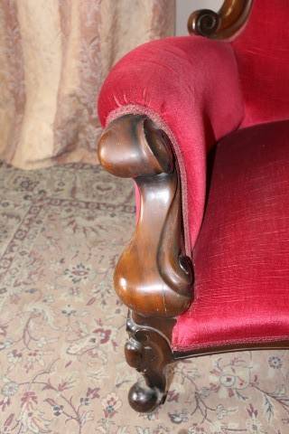 A gorgeous antique Victorian 3 seater settee couch w carved detailing and period style upholstery.