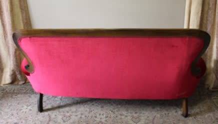 A gorgeous antique Victorian 3 seater settee couch w carved detailing and period style upholstery.