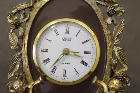A beautiful vintage Japanese brass "Landex" wind up alarm clock with cherubs.  Lifespace Sale