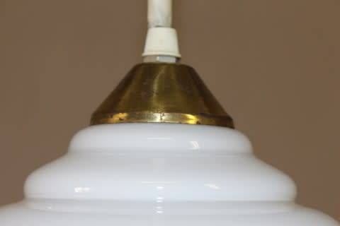 A beautiful white glass single pendant ceiling light, perfect in formal rooms.