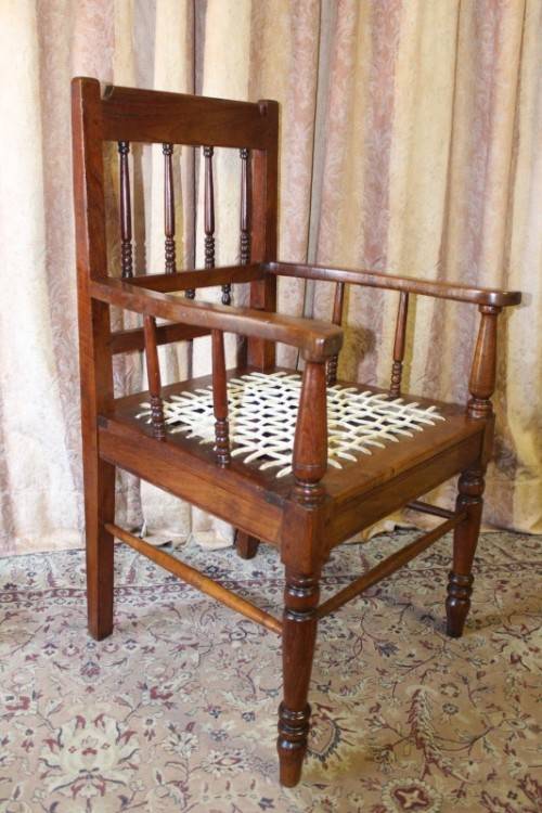 A beautifully made solid Kiaat wood armchair/ carver chair w/ a riempie seat.