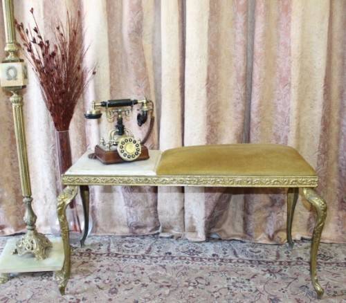 A lovely vintage marble and brass telephone table w/ a cushion, great in informal rooms!