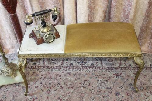 A lovely vintage marble and brass telephone table w/ a cushion, great in informal rooms!