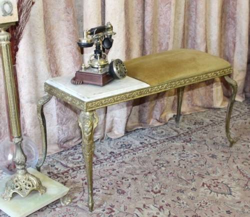 A lovely vintage marble and brass telephone table w/ a cushion, great in informal rooms!