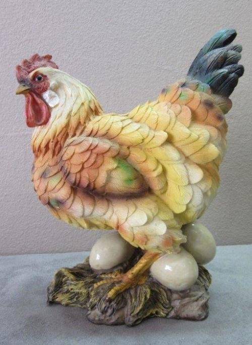 A wonderful little plastic figurine of a hen surrounded by eggs, fabulous on display.