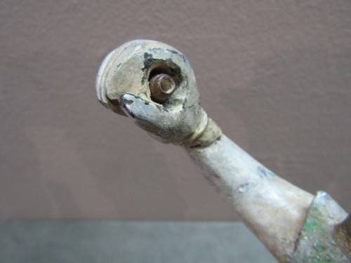 A carved ornamental Oriental wood figurine in traditional dress on a wood base. Lifespace Sale