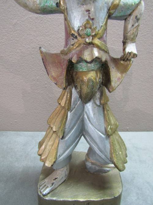 A carved ornamental Oriental wood figurine in traditional dress on a wood base. Lifespace Sale