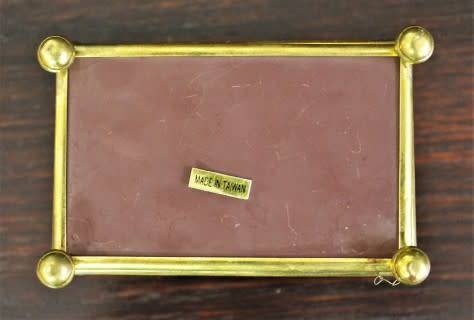 A charming coloured glass trinket box with a gold-coloured frame and mirror base. Lifespace Sale