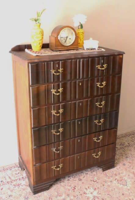 An exquisite vintage Imbuia 7-drawer chest of drawers with ornate handles and ample storage space.