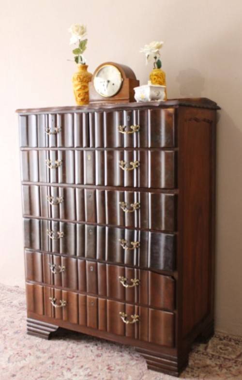 An exquisite vintage Imbuia 7-drawer chest of drawers with ornate handles and ample storage space.