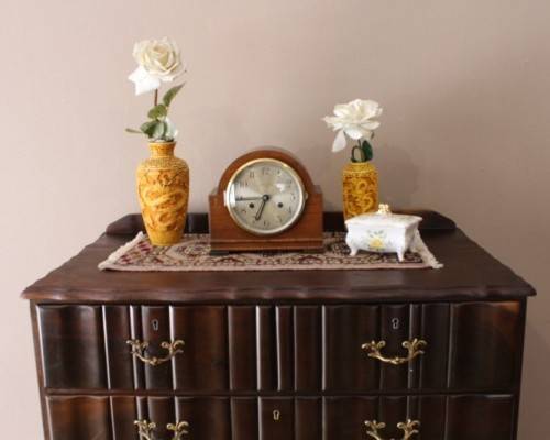 An exquisite vintage Imbuia 7-drawer chest of drawers with ornate handles and ample storage space.