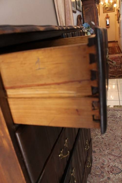 An exquisite vintage Imbuia 7-drawer chest of drawers with ornate handles and ample storage space.