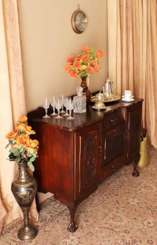 A gorgeous, large vintage Imbuia wood ball & claw buffet/ side server, with carved doors!