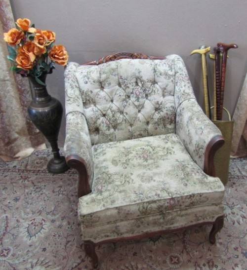 A gorgeous vintage Victorian styled arm chair w deep button, carved detailing & floral upholstery.