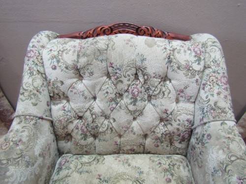 A gorgeous vintage Victorian styled arm chair w deep button, carved detailing & floral upholstery.