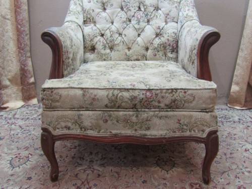 A gorgeous vintage Victorian styled arm chair w deep button, carved detailing & floral upholstery.