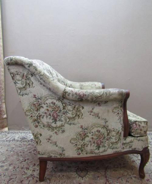 A gorgeous vintage Victorian styled arm chair w deep button, carved detailing & floral upholstery.