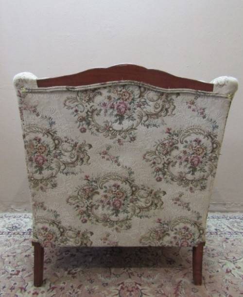 A gorgeous vintage Victorian styled arm chair w deep button, carved detailing & floral upholstery.