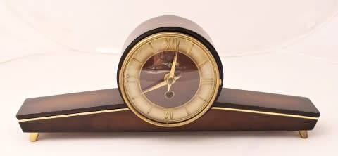 A beautiful wooden Mercedes mantel clock decorate with brass trimmings, working cold. Lifespace Sale