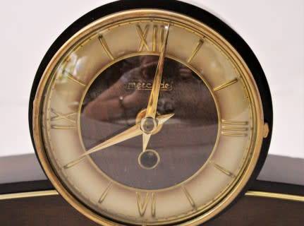A beautiful wooden Mercedes mantel clock decorate with brass trimmings, working cold. Lifespace Sale