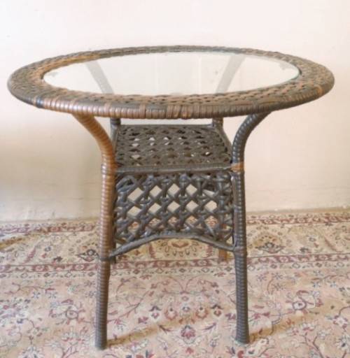 A fabulous four piece woven plastic outdoor patio set, three chairs and table.