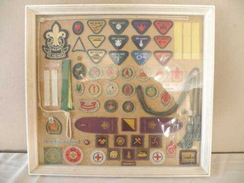A framed behind glass assortment of Scout badges-Lifespace Sale