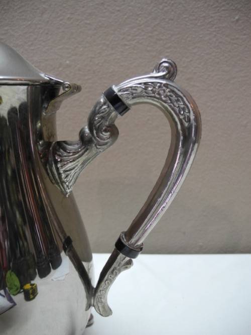A wonderful ornate vintage silver plated teapot w/ a finial lid in good condition.