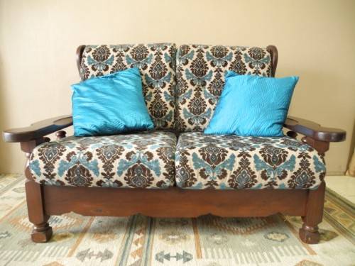 A colourful blue vintage Imbuia 2 seater couch - perfect in a lounge/patio/lapa.