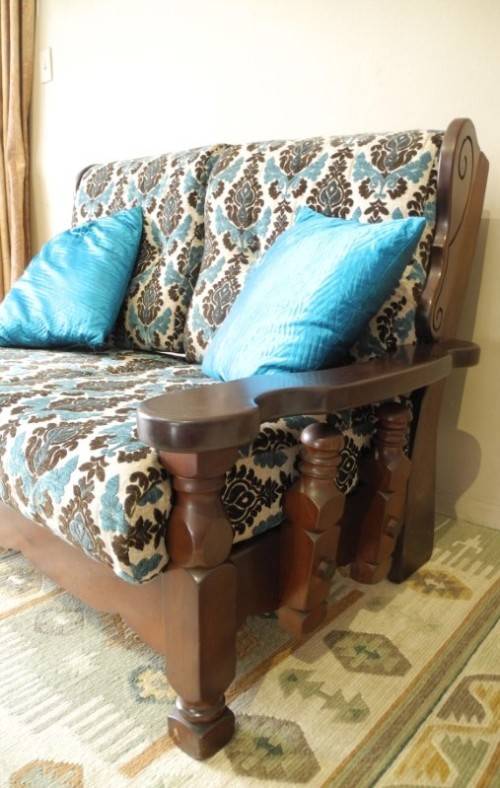 A colourful blue vintage Imbuia 2 seater couch - perfect in a lounge/patio/lapa.