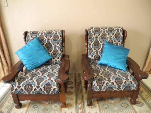 A pair of fabulous floral cushioned vintage Imbuia chairs - perfect in a lapa/patio.