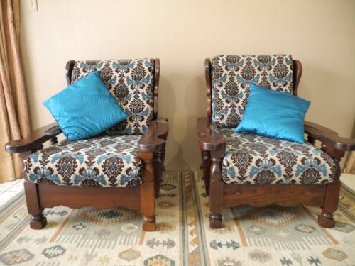 A pair of fabulous floral cushioned vintage Imbuia chairs - perfect in a lapa/patio.