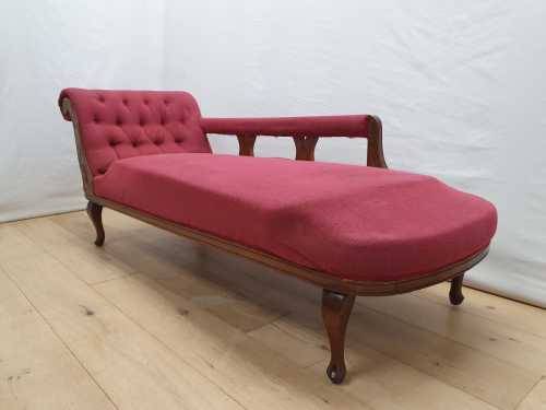 An Edwardian rail-back upholstered Chaise Lounge