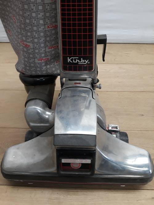 A Kirby vacuum cleaner in working order and a spare for parts (not working)