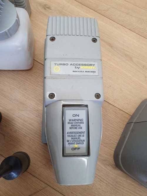 A Kirby vacuum cleaner in working order with extra attachments