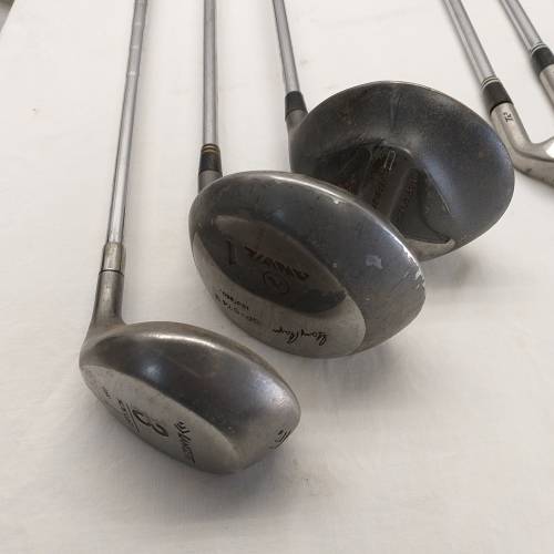 A collection of 11x assorted golf clubs, including irons, woods/ drivers and two putters