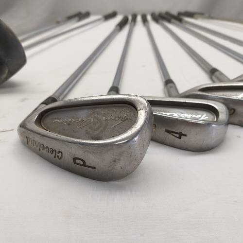 A collection of 11x assorted golf clubs, including irons, woods/ drivers and two putters