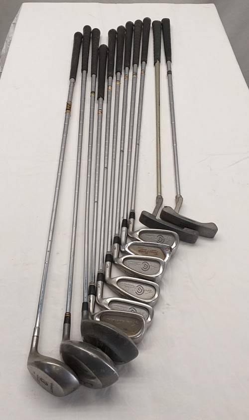 A collection of 11x assorted golf clubs, including irons, woods/ drivers and two putters