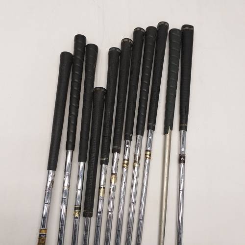 A collection of 11x assorted golf clubs, including irons, woods/ drivers and two putters