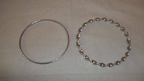 TWO AWESOME SILVER PLATED LADIES BANGLES WITH PRETTY DESIGNS AROUND THEM