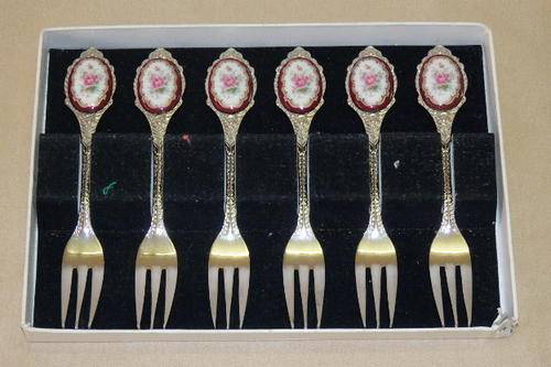 AN AWESOME BOXED SET OF SIX STAINLESS STEEL CAKE FORKS WITH A PORCELAIN INLAY ON THE HANDLE