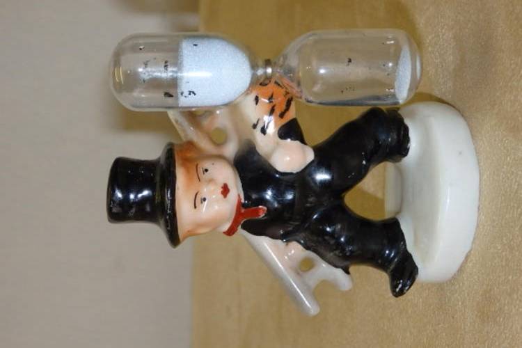 AN AMAZING ANTIQUE (1893 TO 1923) PORCELAIN EGG TIMER FIGURINE OF A CHIMNEY SWEEP