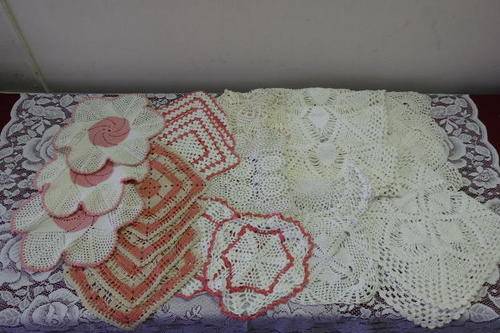 AN INCREDIBLE COLLECTION OF 23 ASSORTED HAND CROCHETED TRAY DOILIES IN VARIOUS SHAPES AND SIZES