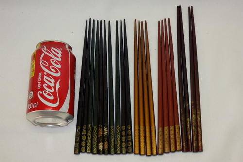 ELEVEN PAIRS OF ORIENTAL (WOODEN) LACQUERED CHOPSTICKS WITH DETAILING ON THE "HANDLES" bid/pair