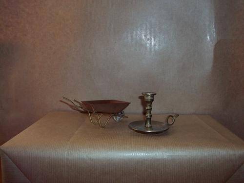 Miniture brass candlie holder and a Copper wheel barrow small