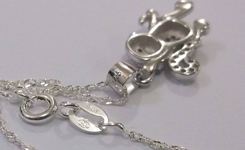 A CUTE STERLING SILVER MONKEY WITH BANANA PENDANT PLUS A 45 CM STERLING SILVER NECKLACE