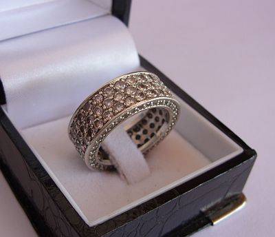 A BEAUTIFUL SOLID STERLING SILVER ETERNITY RING SET WITH MANY FACETED CZ STONES