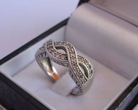 A SENSATIONALLY DESIGNED STERLING SILVER RING SET WITH SUPER FACETED CZ STONES