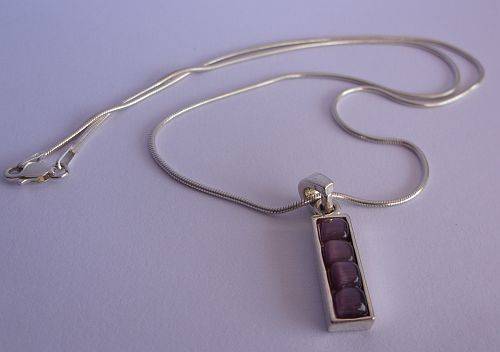 A BREATHTAKING STERLING SILVER NECKLACE WITH STERLING SILVER PENDANT SET WITH CABOCHON AMETHYSTS